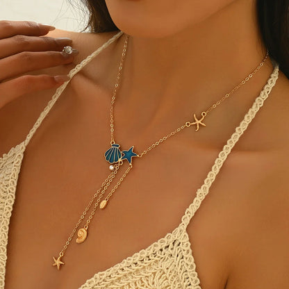 Collar Dorado Elegante con Estrella y Concha Azul